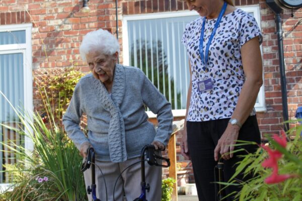 home-care-helper-in-garden-with-patient